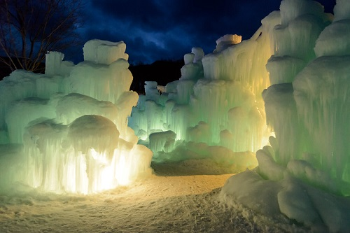 A castle made of ice is lit up at night in white mountain national forest