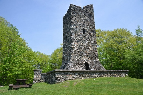 A stone tower in Montpelier with a picnic table in front of it