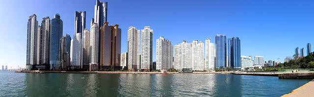 The Busan skyline with a body of water in the foreground.