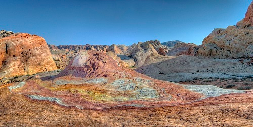 A desert landscape with rocks and mountains in the background