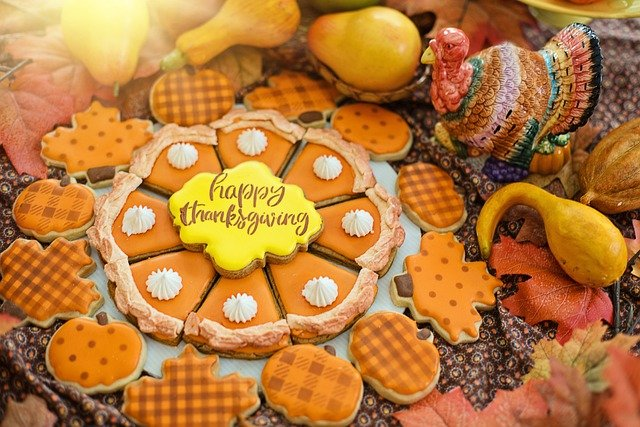 A plate of thanksgiving cookies in the shape of a pumpkin pie.