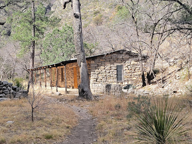 The Hunter Line Shack in the middle of a field surrounded by trees in guadalupe mountains np