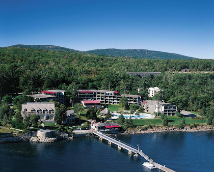 An aerial view of a large body of water with mountains in the background near Acadia NP