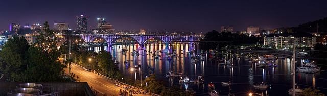 An aerial view of Knoxville at night with a harbor in the foreground.