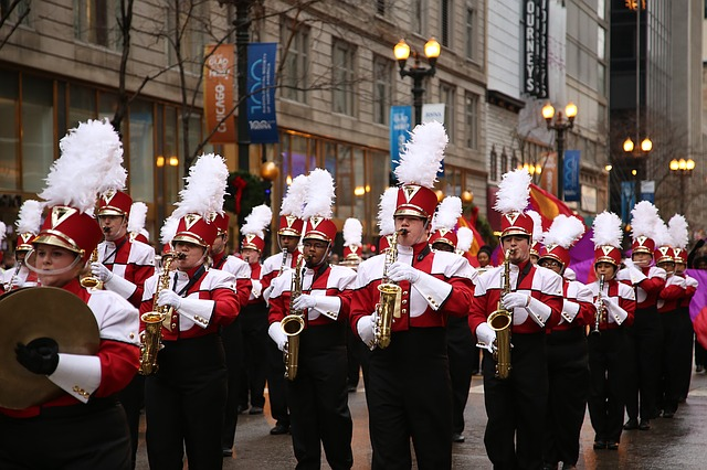 A marching band is marching down a city street in Chicago