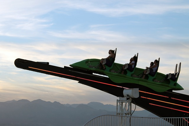 A group of people are riding a roller coaster at The Strat in Las Vegas