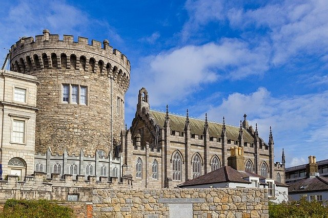 A large stone building with dublin castle in the background.