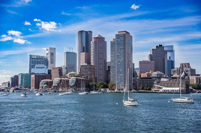 The Boston skyline with boats in the water in front of it