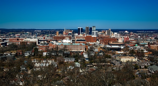 An aerial view of Birmingham with a blue sky in the background.