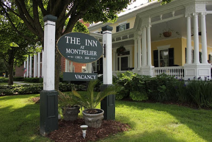 A sign for the inn at montpelier in front of the hotel