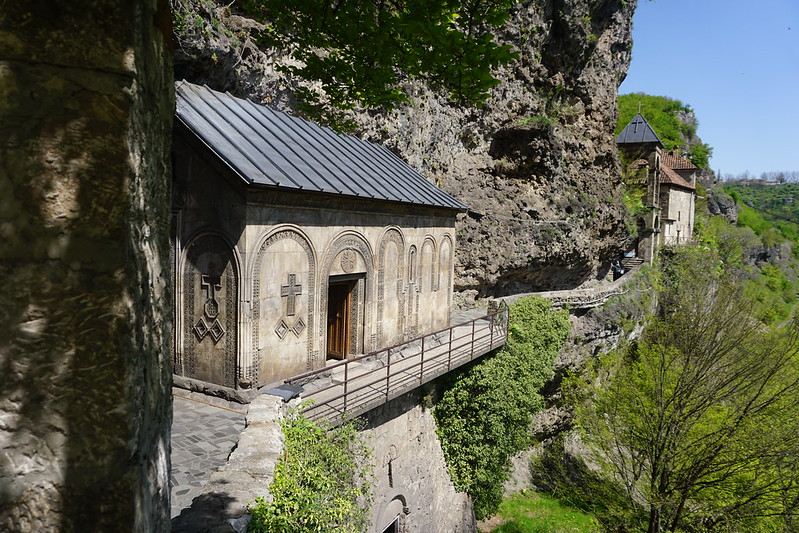 There is a small building on the side of a cliff in georgia