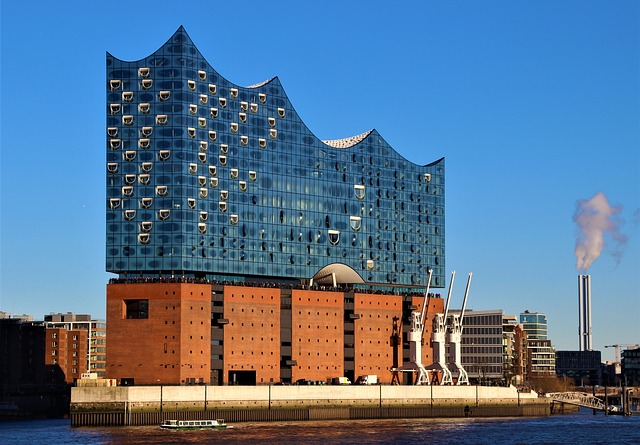 A large building with a lot of windows is next to a body of water in Hamburg