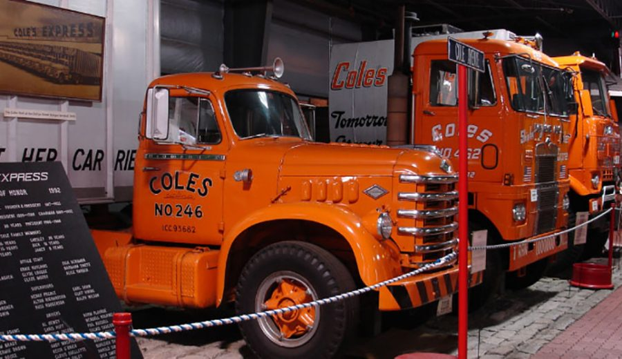 A coles truck is parked next to another truck in a Bangor museum