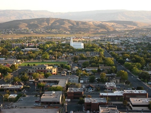 An aerial view of a city with mountains in the background