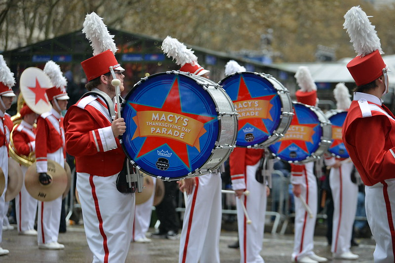 A marching band is performing at macy 's holiday parade