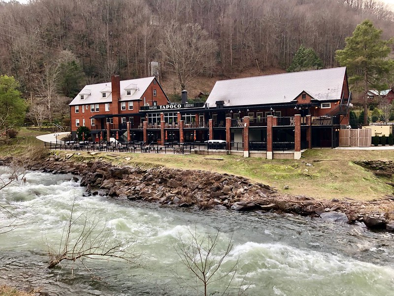 A large hotel set next to a river in the middle of Great Smoky Mountains NP