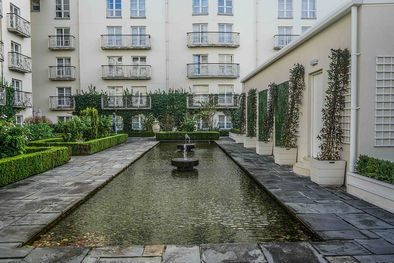 The merrion hotel with a fountain in the middle of it