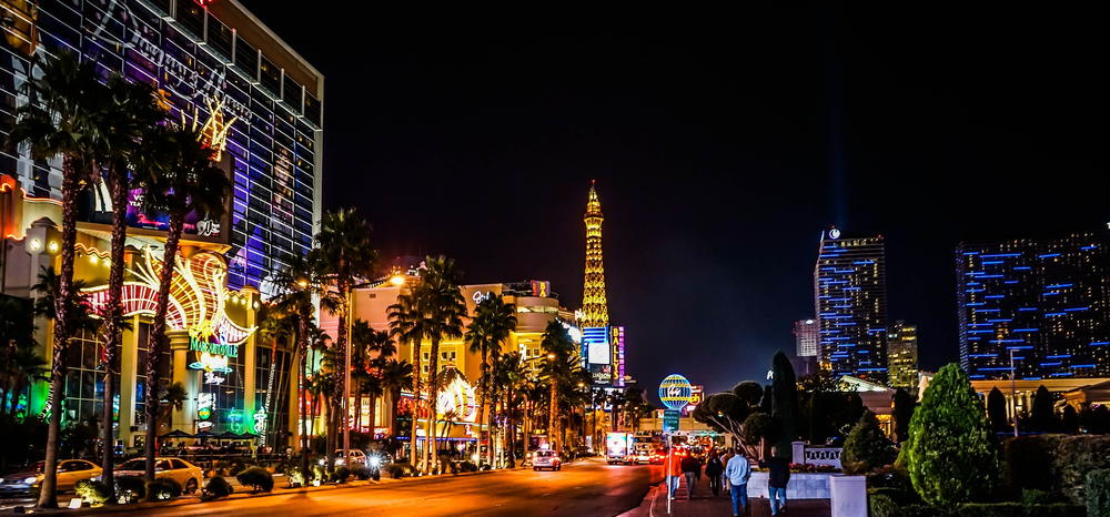 A picture of the Las Vegas strip at night with a lot of lights on.