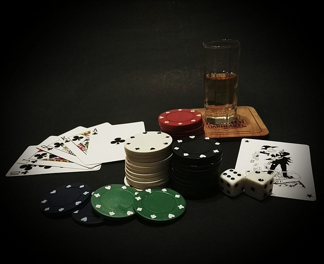 A stack of poker chips playing cards dice and a glass of alcohol in Las Vegas