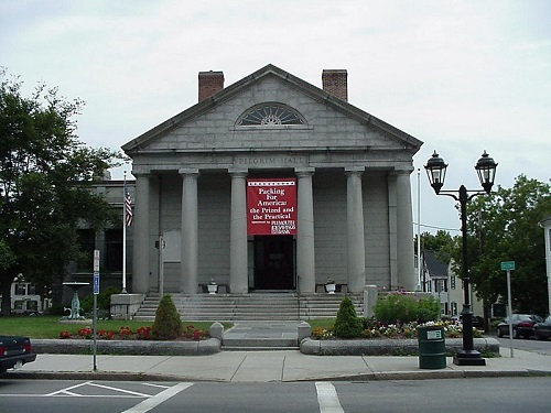 A large building with a red banner hanging from the front in Plymouth