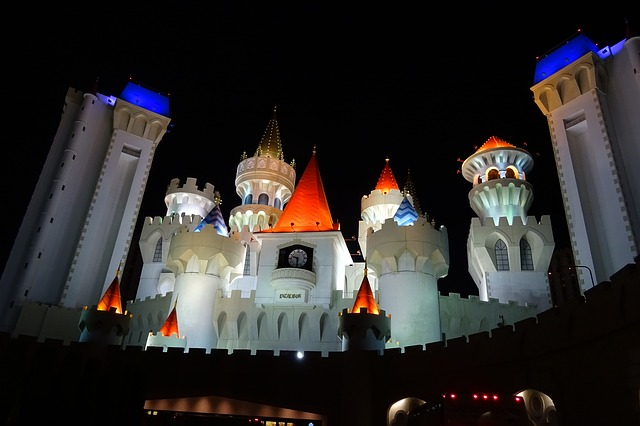 The Excalibur Hotel & Casino in Las Vegas is lit up at night and looks like a fairy tale castle.