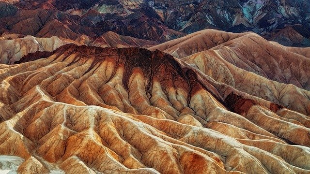 An aerial view of a desert landscape with mountains in the background  in Death Valley National Park