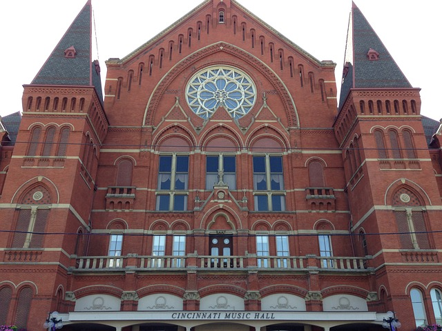 A large red brick building with a clock on the top in Cincinnati