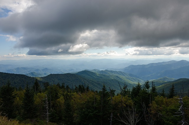 A view of a mountain range with trees and clouds in the sky in Great Smoky Mountains NP