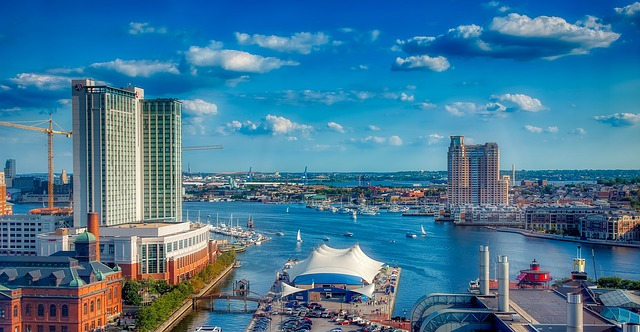 An aerial view of Baltimore with buildings and a body of water.