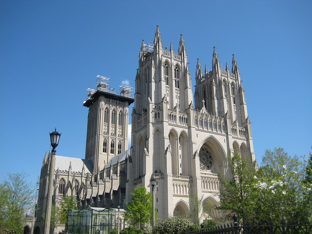 A large cathedral in Washington DC with a blue sky in the background