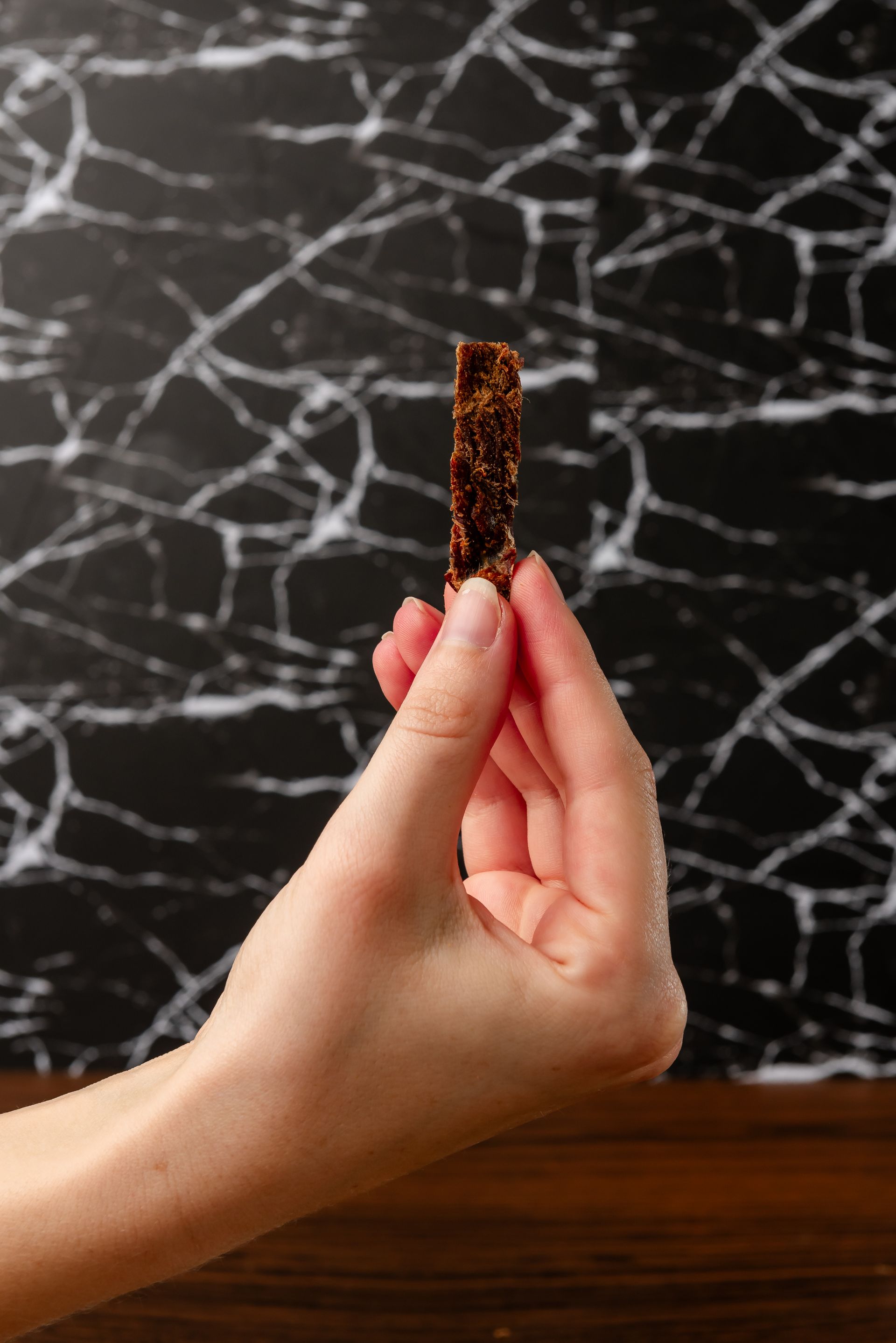 A bag of clayton 's smokey bbq jerky on a wooden table