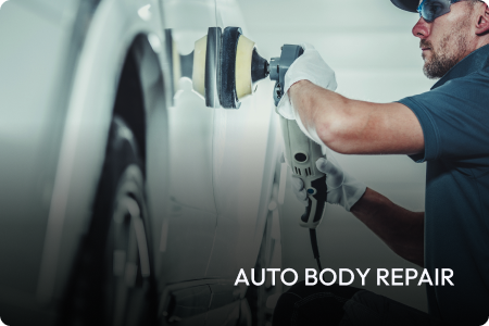 A man is working on a car in a garage.