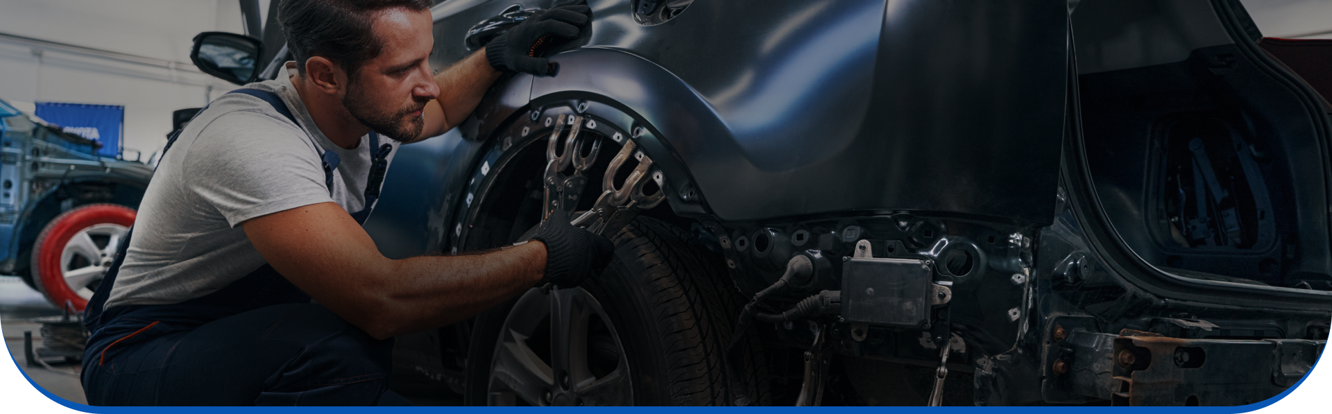 A man is working on a car in a garage.