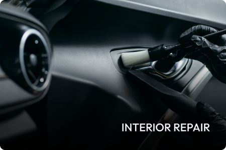 A person is polishing a blue car with a polisher.