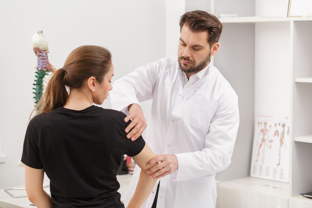 Doctor Examining a Patient's Shoulder  — Back Care Gold Coast In Molendinar, QLD