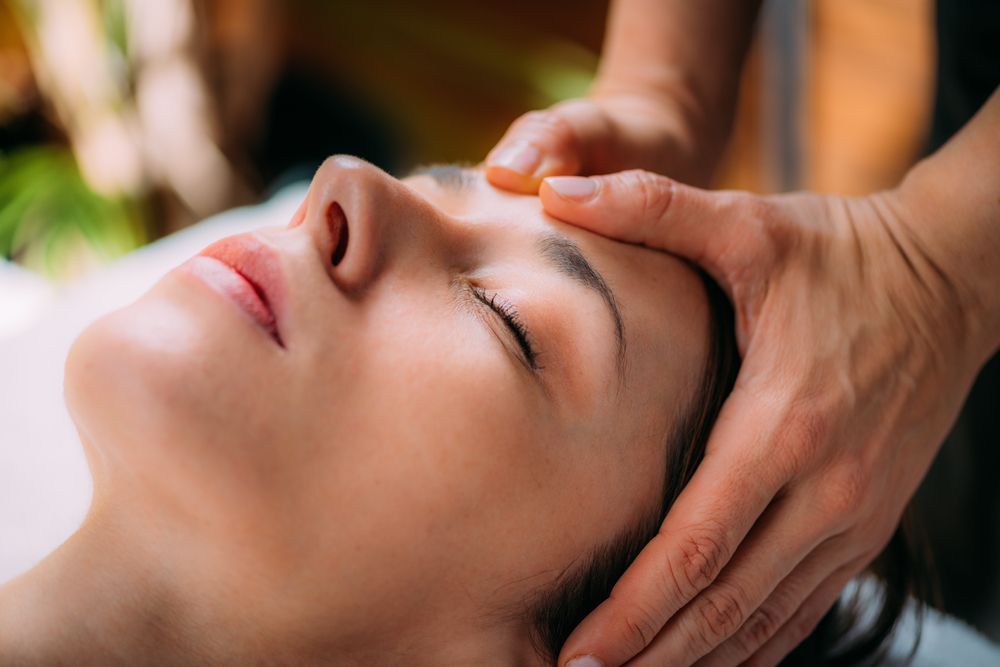 A Woman is Getting a Head Massage at a Spa — Back Care Gold Coast In Nerang, QLD