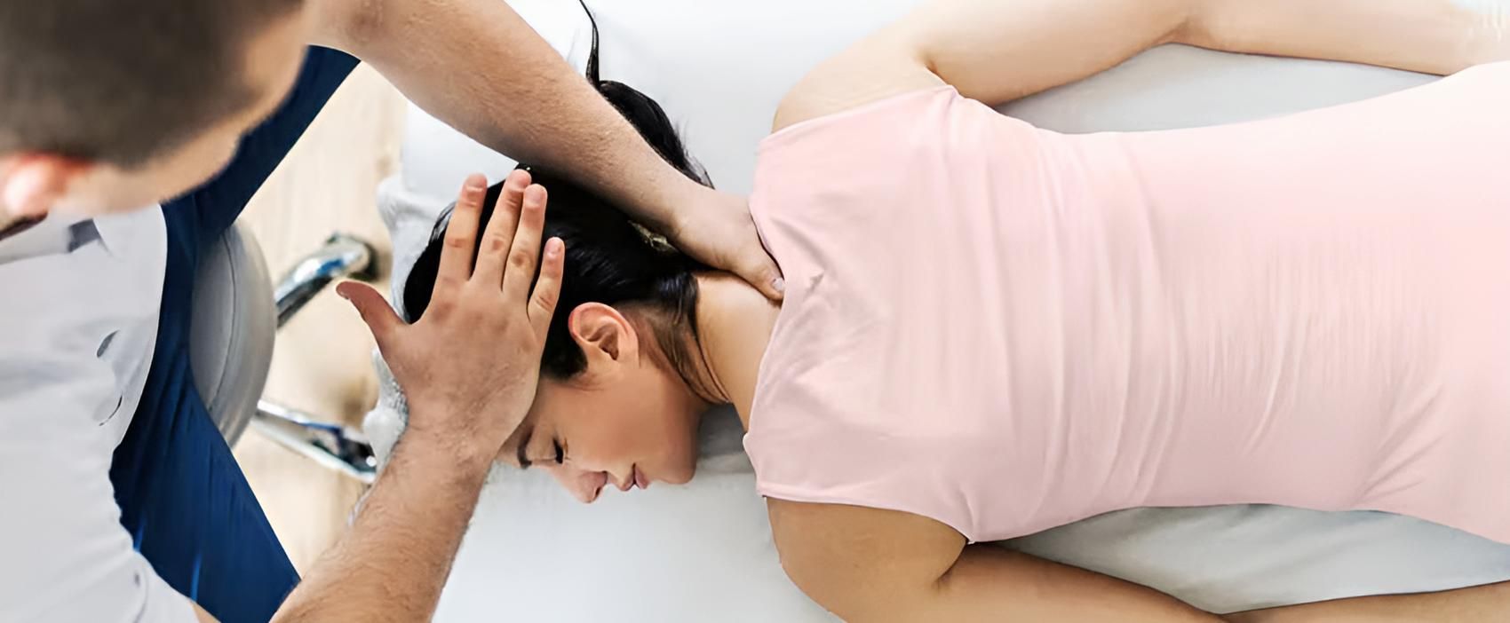 A Man is Giving a Woman a Massage on a Bed — Back Care Gold Coast in Nerang, QLD