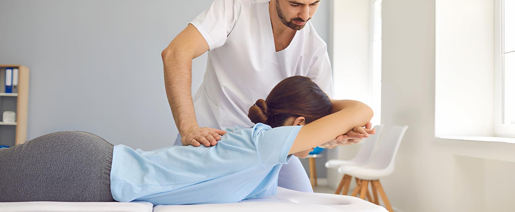 A Man is Giving a Woman a Massage on a Bed — Back Care Gold Coast in Nerang, QLD