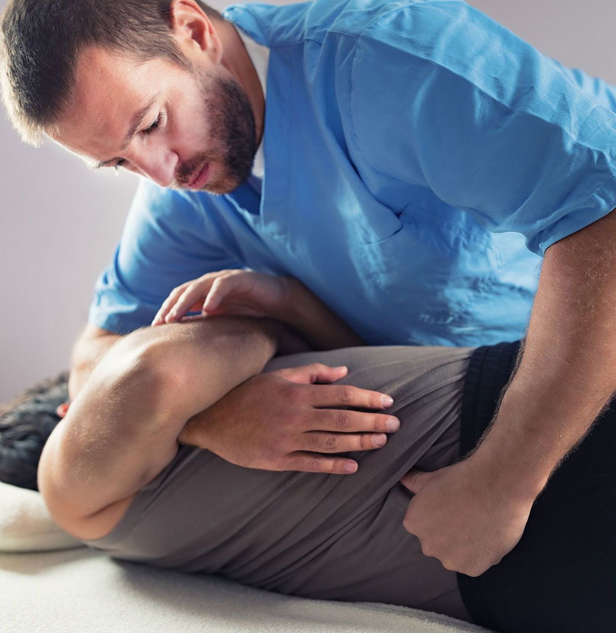 A Man is Giving a Woman a Massage on a Table — Back Care Gold Coast In Nerang, QLD