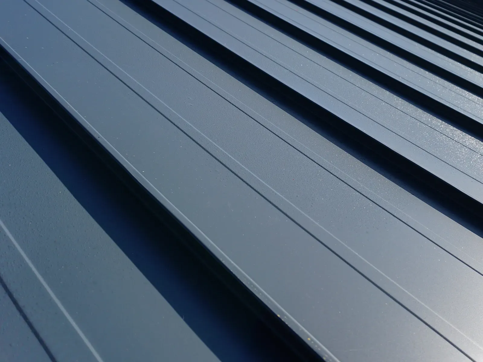 Interlock Standing Seam aluminum metal roof panels with raised seams, close-up, Portland, Oregon.