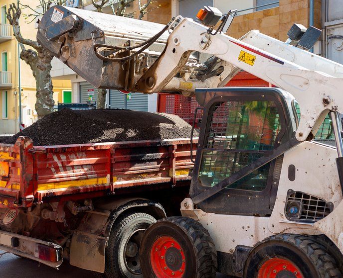 Bobcat dumping asphalt for Steer Bobcat picture