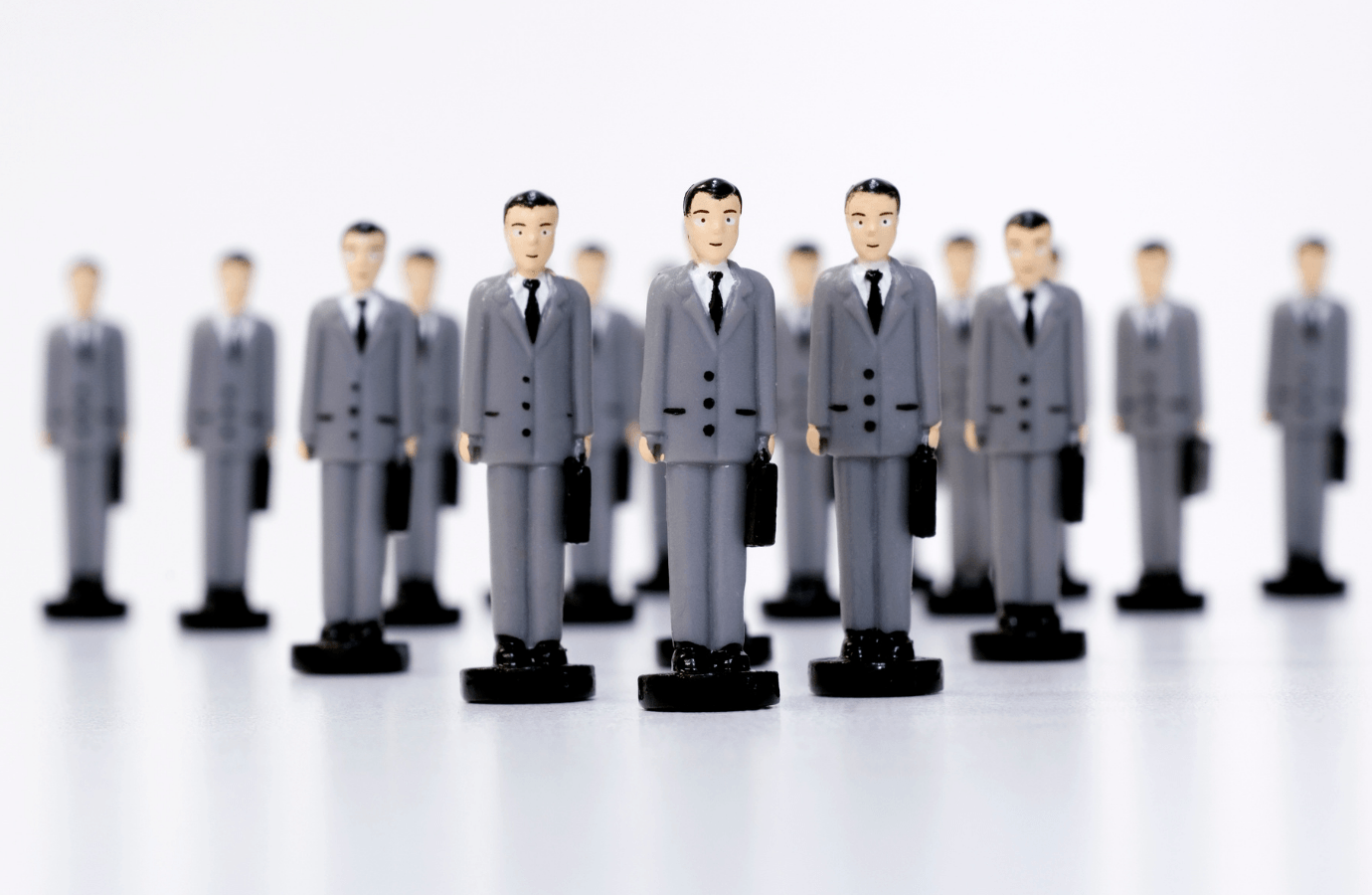 plastic army men dressed in business suits