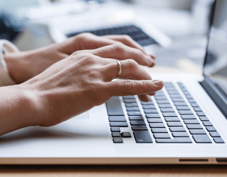 close up of hands typing