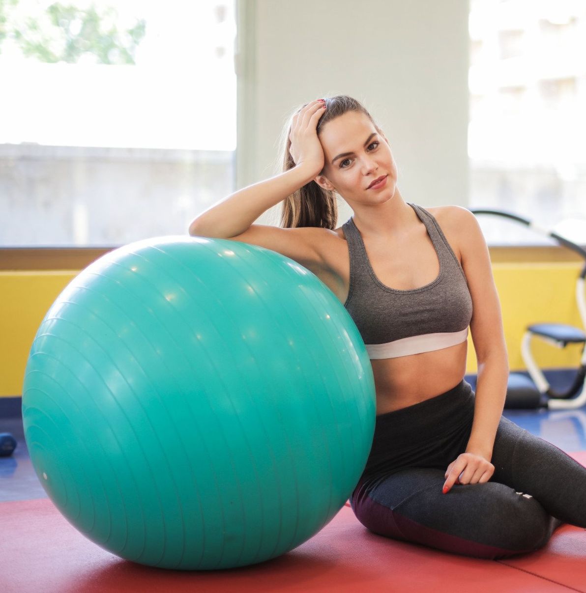 woman in fitness center with balance ball