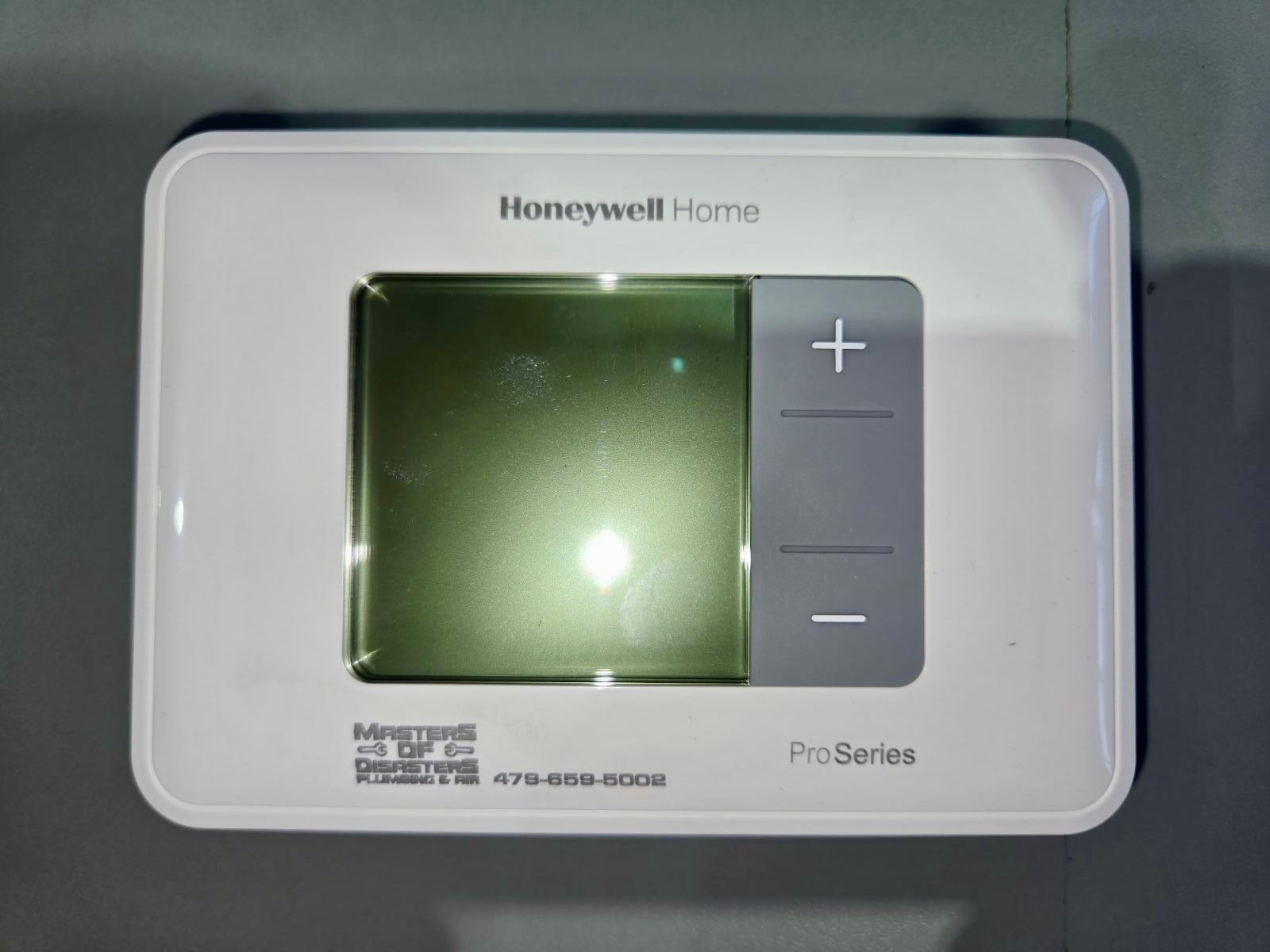 A thermostat installation in Springdale, AR - Masters of Disasters hard at work