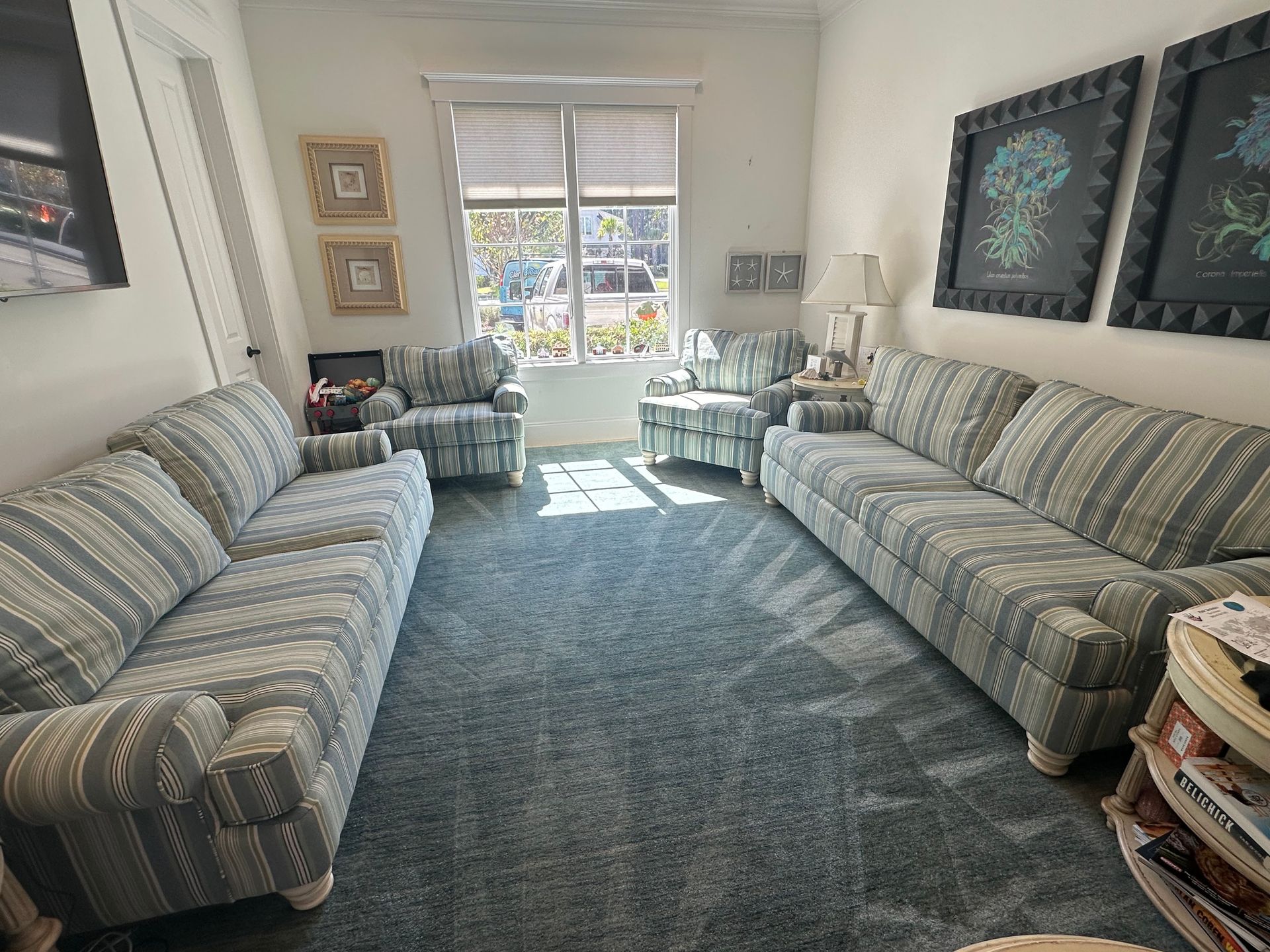 A living room with two couches and two chairs.