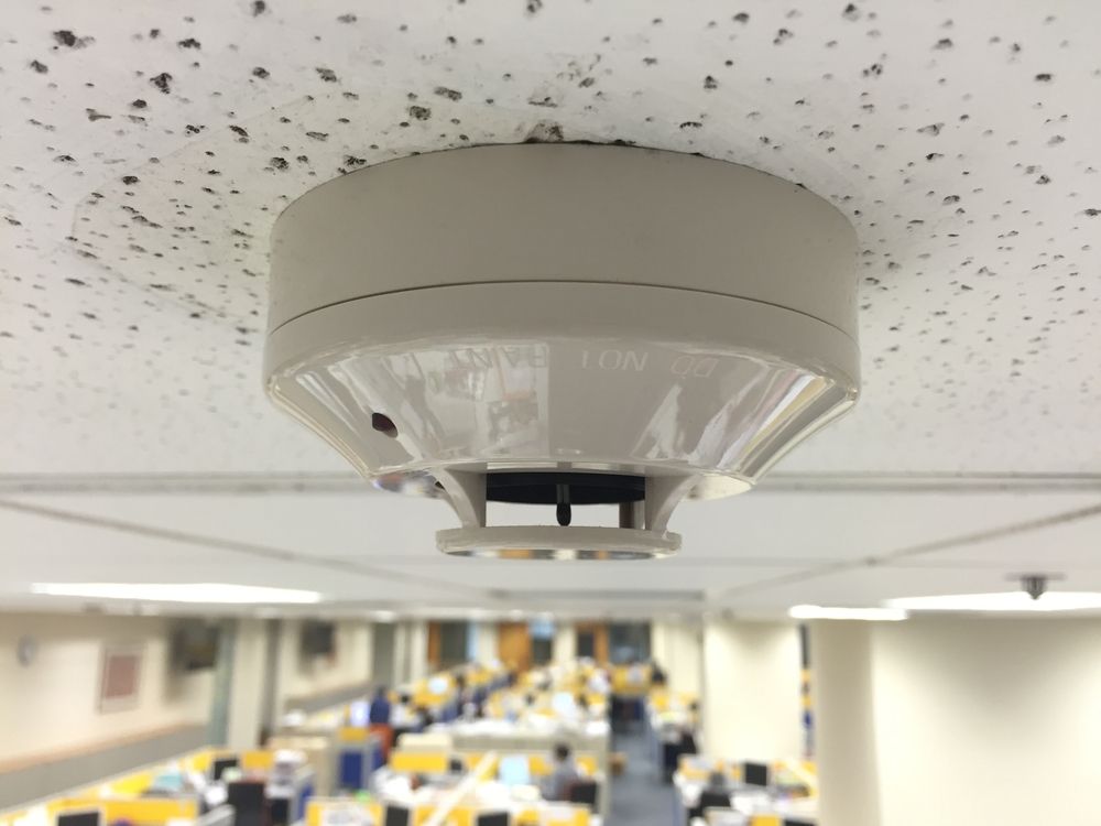 Smoke Detector Mounted on a White, Speckled Ceiling — Do Right Electrical in Redlynch, QLD