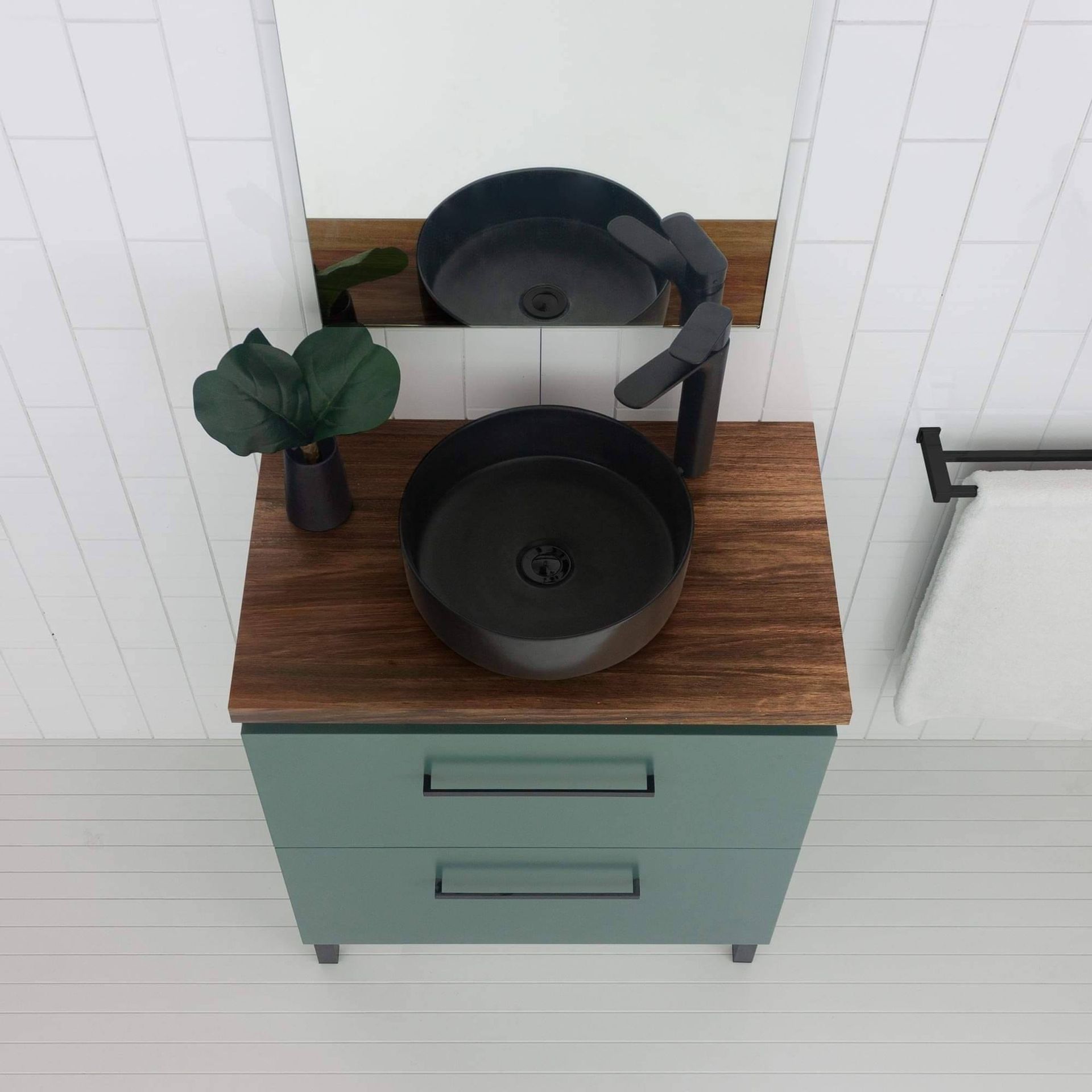 A bathroom vanity with two sinks and a mirror.