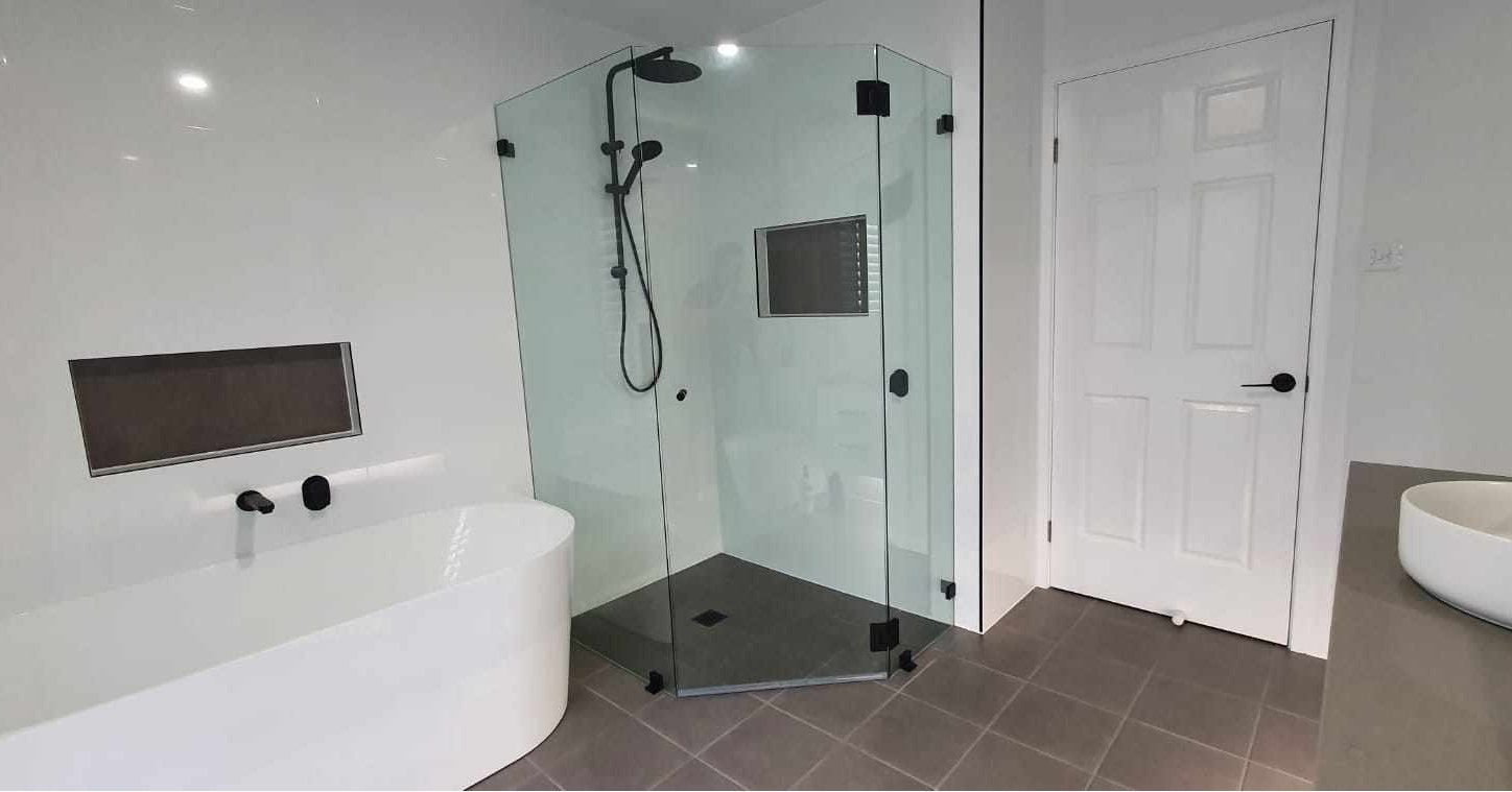 A bathroom with a bathtub, shower, sink and toilet.