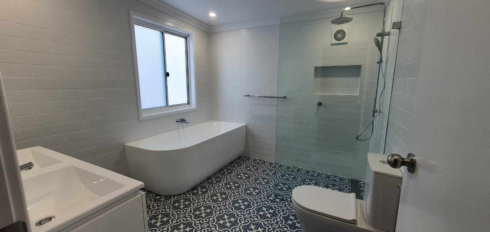 A bathroom with a bathtub, toilet, sink and shower.